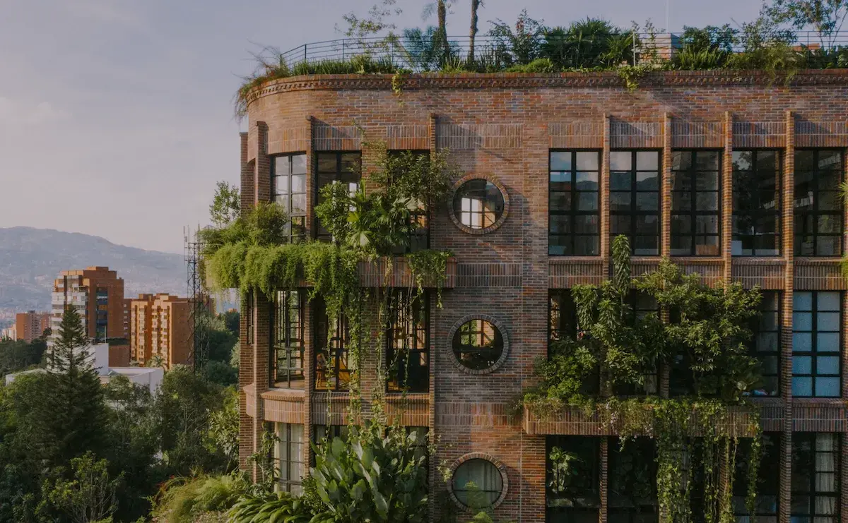 Brick arches and planted terraces at Edificio El Universal in Medellín